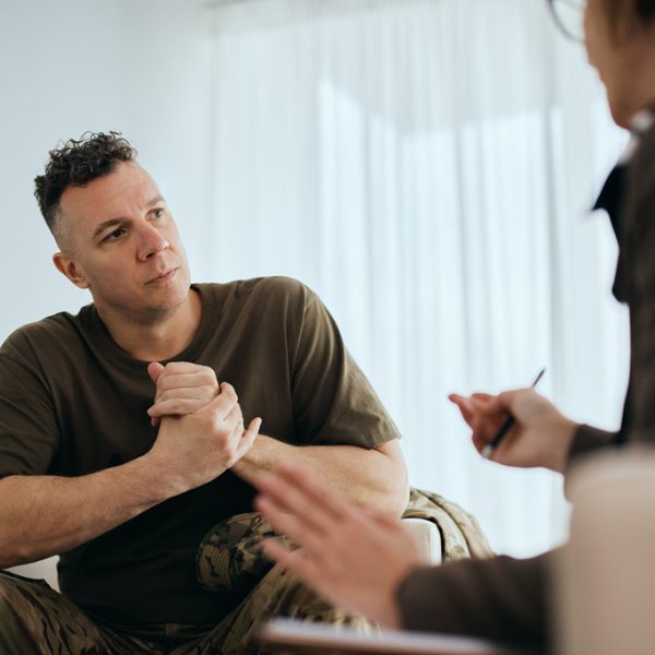 Mid adult veteran talks about his issues with mental health therapist.